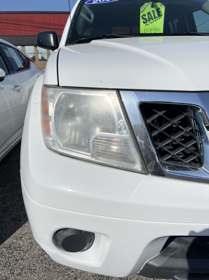 Before Nissan Frontier headlight restoration — yellowed lens